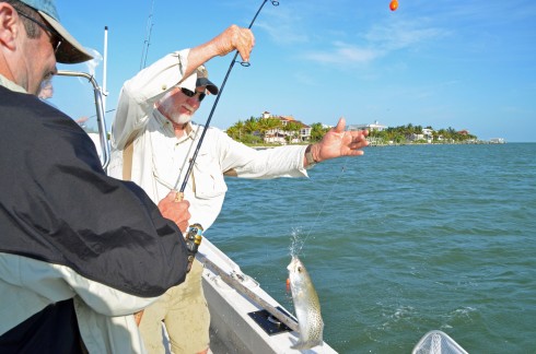 Jim helps Brian land a trout - Santiva Salt Water Fishing