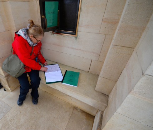 Signing the Guest Book at Ranville War Cemetery