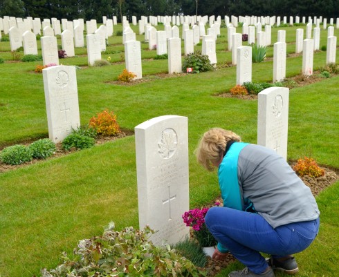 Alison laying flowers at John's grave